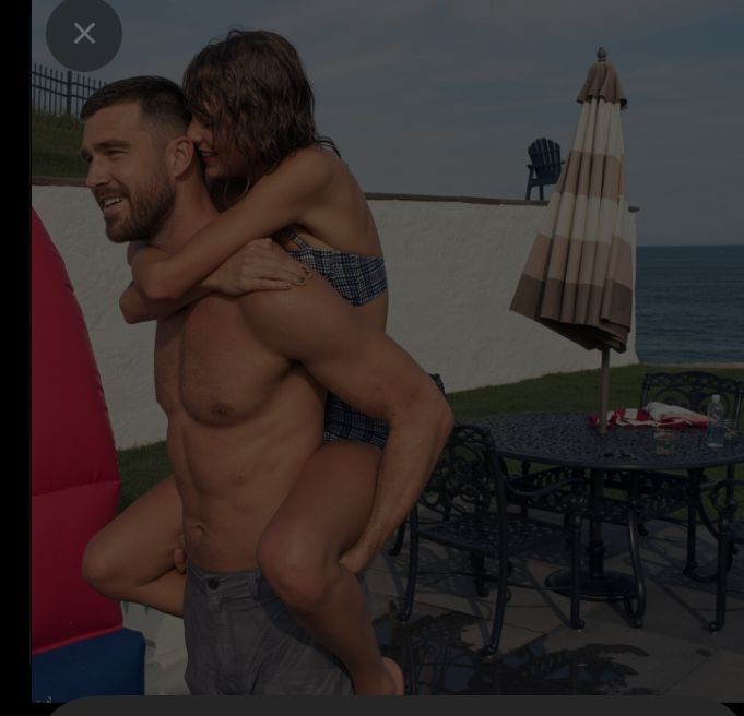 **Married Taylor Swift Recreates Her Most Famous Calvin Harris Beach Photo With Husband Travis Kelce — And the Internet Is Losing It**
A photo of Taylor Swift riding on Travis Kelce’s shoulders at a beachside patio is circulating widely and reigniting one of the most divisive comparisons in her dating history.
The image shows the newlyweds in a playful, almost identical pose to the well-known 2015 photo of Swift on Calvin Harris’s shoulders during a Fourth of July weekend. In the circulating shot, Kelce is shirtless in gray pants while Swift, in a blue-and-white checkered bikini top, clings to his shoulders as they smile near the water. The setting features a patio table, striped umbrella, and ocean backdrop.
Swift and Kelce married on July 3, 2026, in a star-studded ceremony at Madison Square Garden. Since the wedding, the couple has largely stayed out of the spotlight, making the sudden appearance of this candid-style photo especially jarring for fans.
Social media reaction has been immediate and split. Some Swifties are calling the image “soft married energy” and celebrating the couple’s chemistry. Others are pointing out the striking similarities to the Calvin Harris photo and questioning why Swift would recreate a moment so closely tied to a previous relationship. The “Taylor’s type has always been built like a linebacker” discourse has returned in force, while others accuse the photo of being staged or calculated.
The original Calvin Harris version of the shot has also resurfaced alongside the new image, fueling side-by-side comparisons and fresh timeline speculation. Comments sections on major platforms are already filling with arguments about whether the photo is endearing or tone-deaf.
Neither Swift nor Kelce’s teams have commented on the circulating image. As of now, it remains unclear whether the photo is a recent candid, an old unseen shot, or something else entirely. What is clear is that it has successfully restarted the exact conversation many assumed ended once the couple said “I do.”