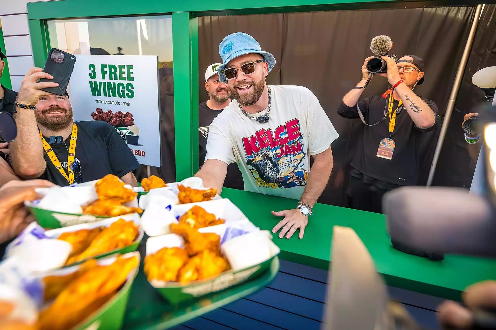 Travis kelce and fans enjoying food from some local Kansas City restaurants present at the event.