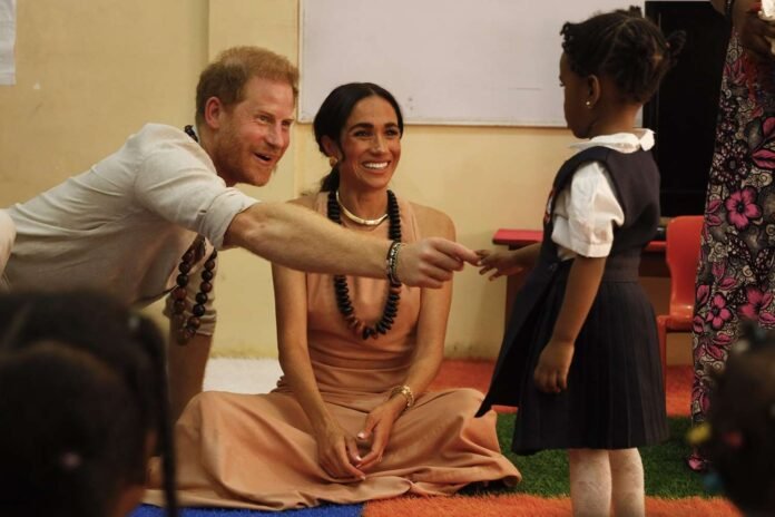 Moment Meghan Markle and Prince Harry discuss Prince Archie's birthday as they sit with school children in Nigeria